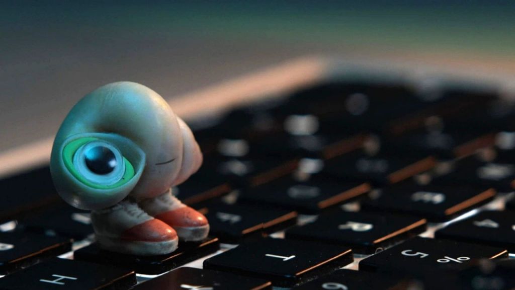 Marcel the shell with shoes on looking at screen